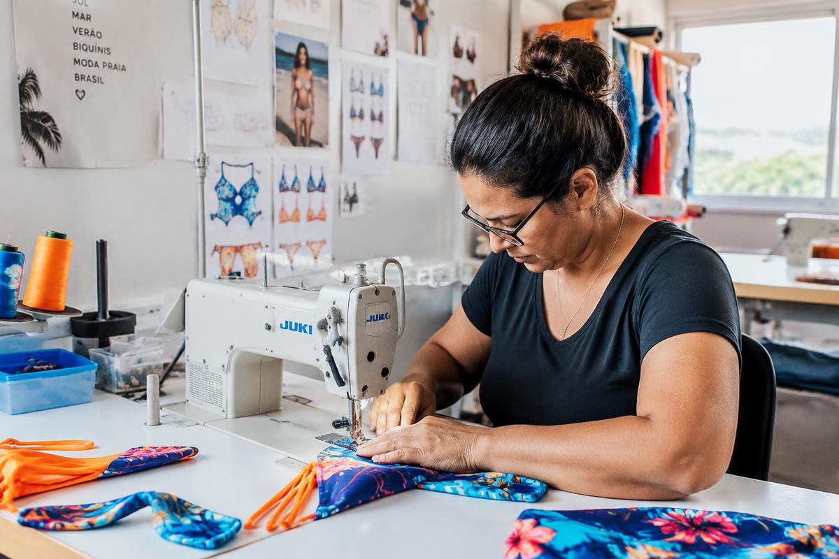 Seamstress sewing custom swimwear in our Brazilian factory